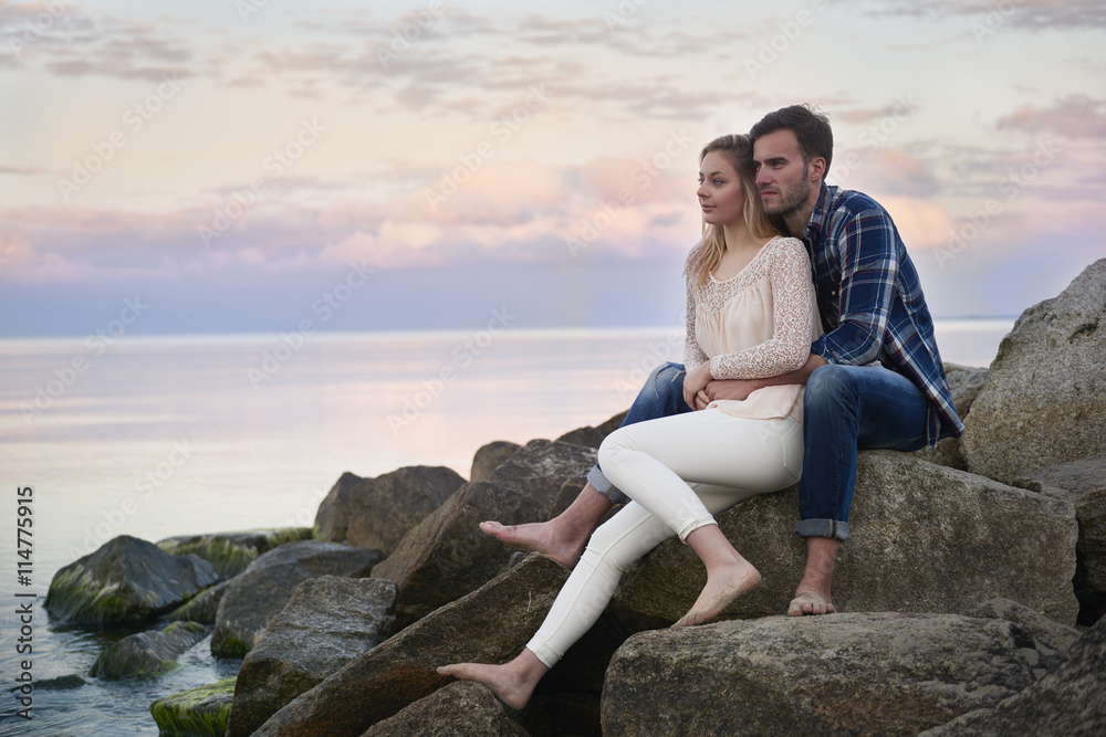 Relaxing couple on the rocks
