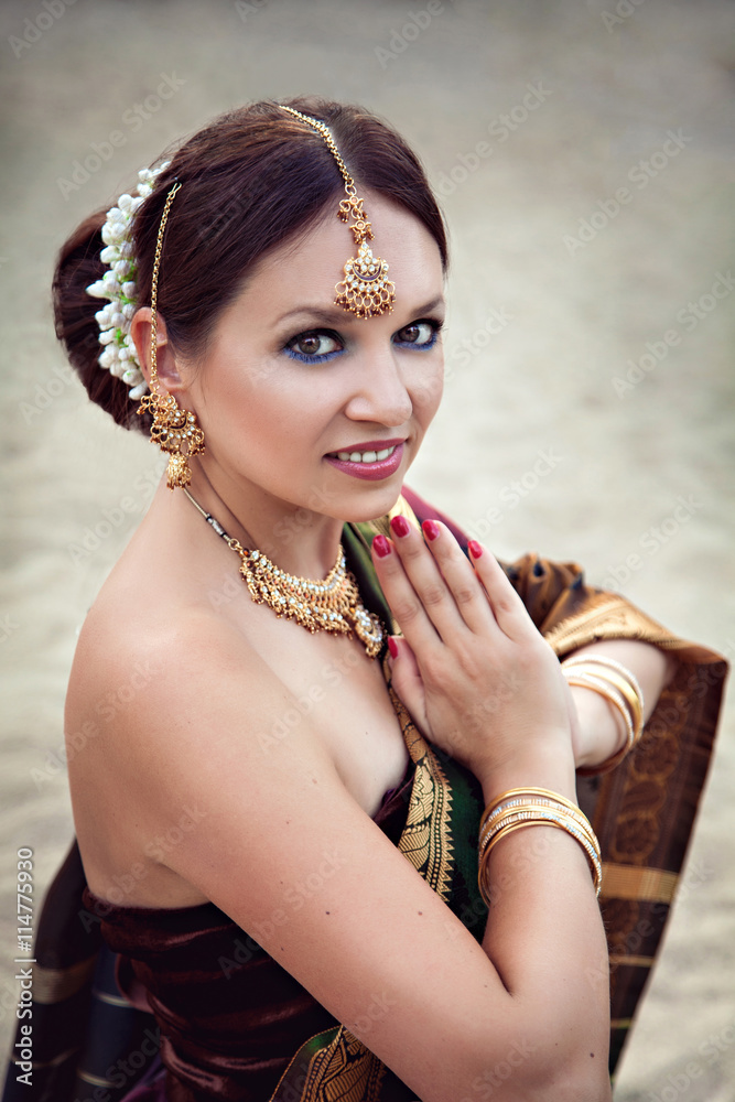 Beautiful woman with oriental makeup and jewelry