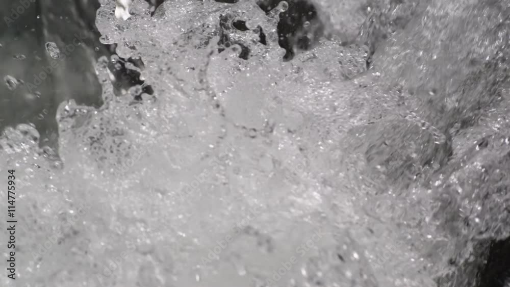 Close-up bubbling splashing water at the foot of a falls Close-up bubbling splashing water at the foot of a falls