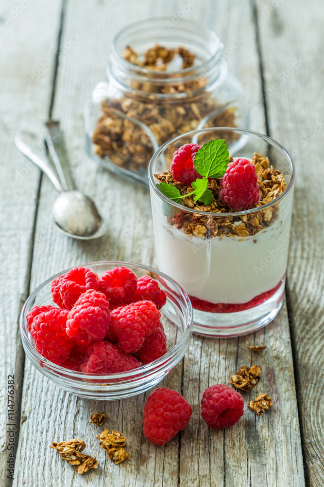 Granola with rasberry and yogurt in glass Granola with rasberry and yogurt in glass
