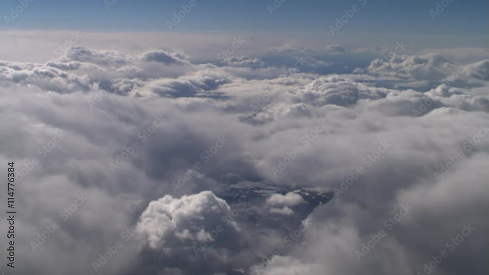 Very slow flight over cumulus clouds