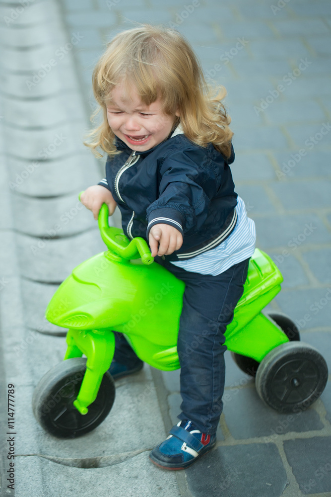 Little boy cries on bicycle Little boy cries on bicycle