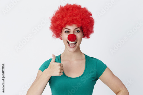 Thumbs up clown in red wig, studio