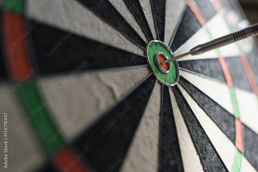 Single dart hitting bull's eye on the dartboard Single dart hitting bull's eye on the dartboard