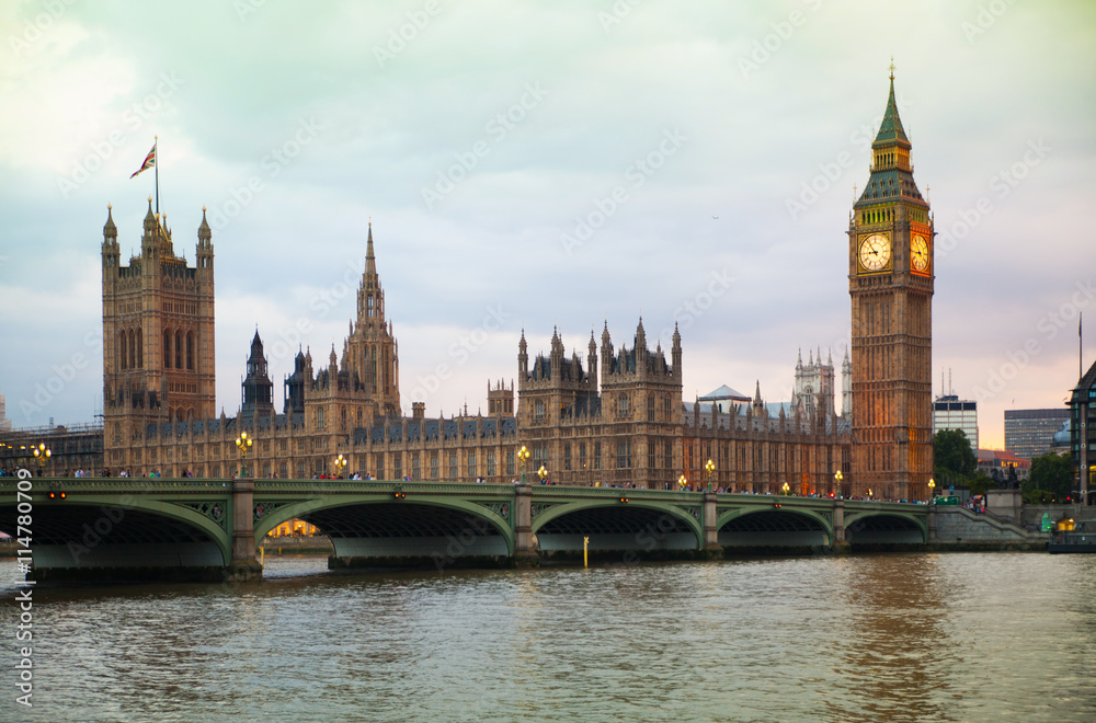 LONDON, UK - JULY 21, 2014: Big Ben and Houses of Parliament at sunset and first night lights LONDON, UK - JULY 21, 2014: Big Ben and Houses of Parliament at sunset and first night lights