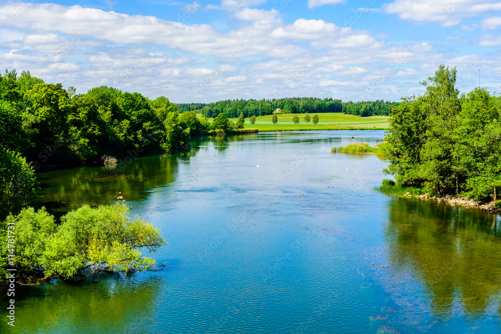 View over Norsholm nature reserve in Sweden. The river is Motala strom. In the distance there is a house. Summer in the Swedish landscape.
