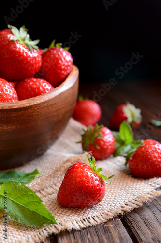 Strawberries in a bowl on black background