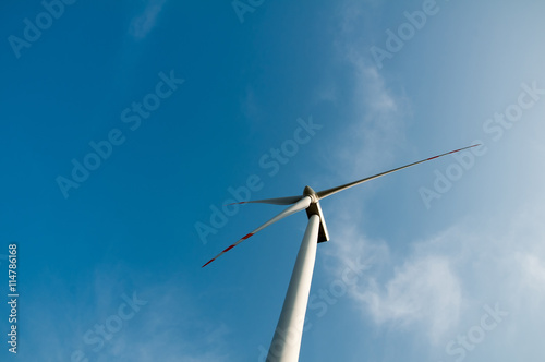 Wind turbine on blue sky © inventart