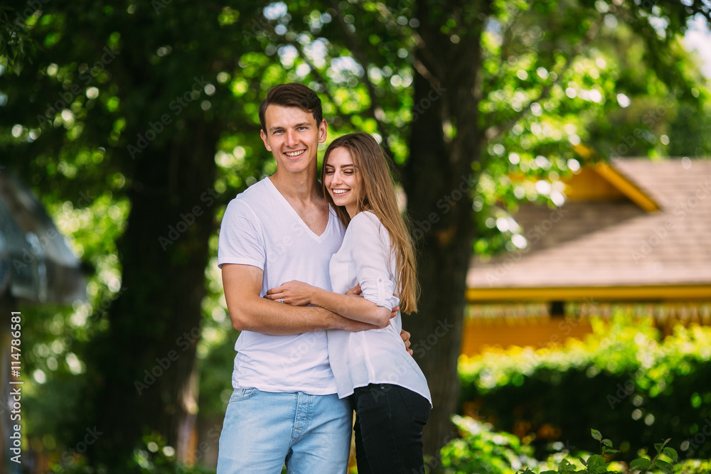 Young adult brunette man and woman in the park