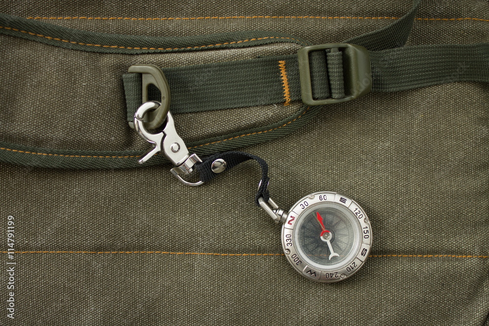 Naklejka premium Compass with safety hook on the strap of a backpack