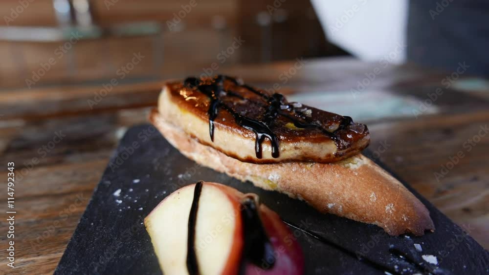 Delicious snack of foie on slice of bread with apple.