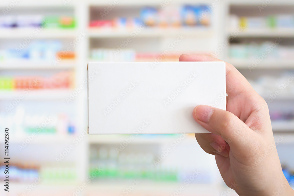 Close up pharmacist hand hold medicine box package Close up pharmacist hand hold medicine box package