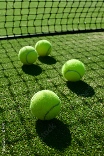 selective focus. tennis ball back light shadow on tennis grass c © kireewongfoto