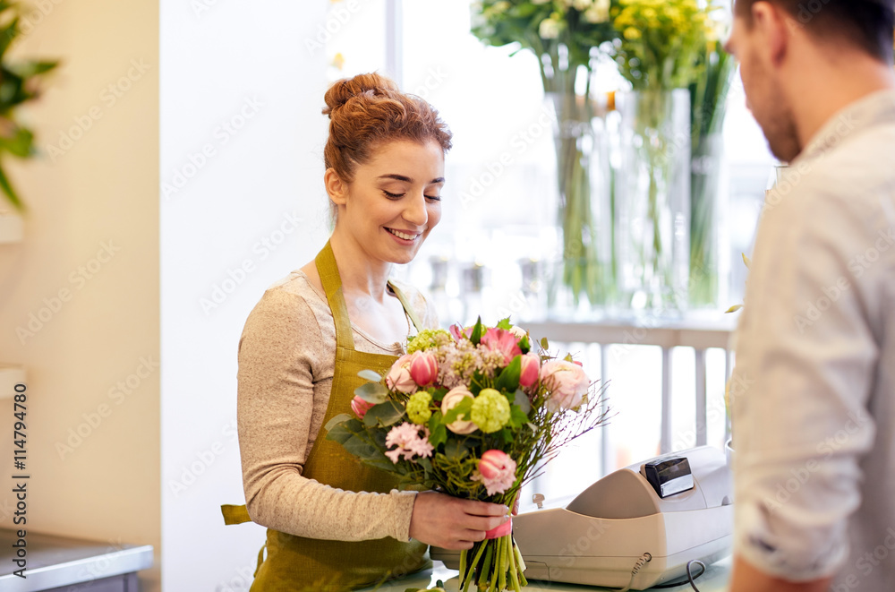 smiling florist woman and man at flower shop