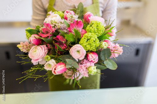 close up of woman holding bunch at flower shop #114794714