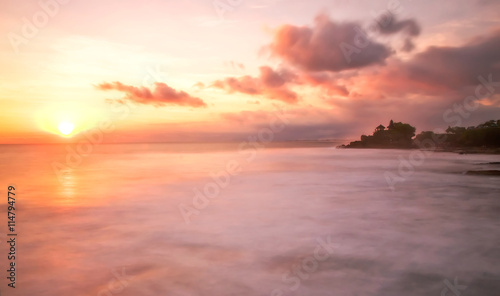 Sunset over Tanah Lot Temple on Sea in Bali Island Indonesia