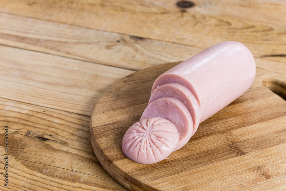 Sliced pork bologna salami on the wooden board Sliced pork bologna salami on the wooden board