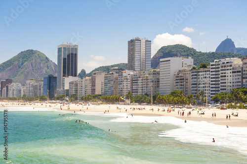 Scenic view of Copacabana Beach shore from the Leme end with the city skyline of Rio de Janeiro, Brazil