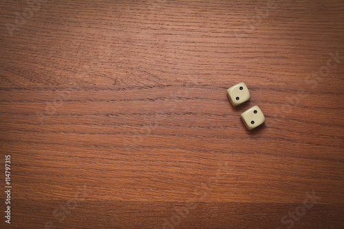 two dice on a wooden table value of two