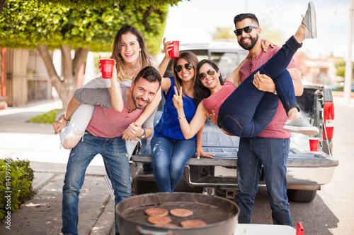 Group of people tailgating and grilling burgers photo