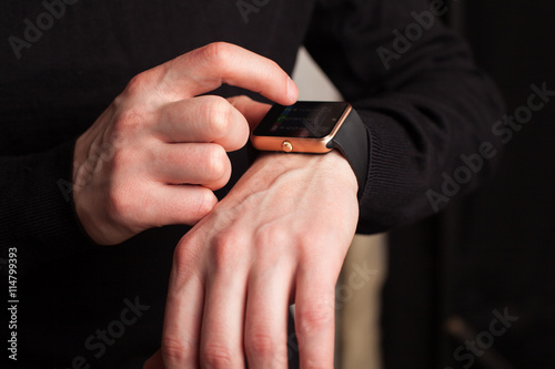 Hands of man with smartwatch