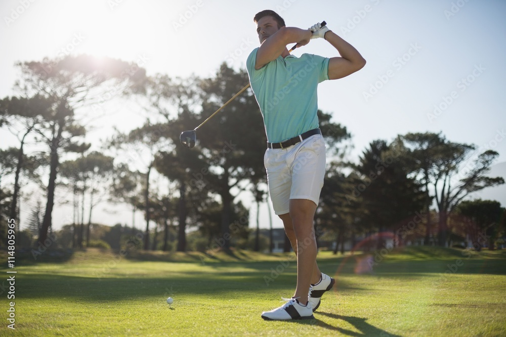 Full length of handsome golfer man taking shot Full length of handsome golfer man taking shot
