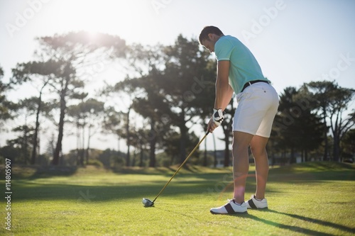 Full length of young man playing golf
