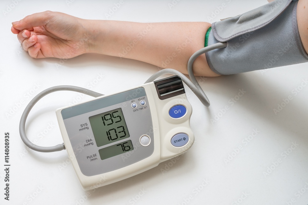 Hypertension concept. Man is measuring blood pressure with monitor. Hypertension concept. Man is measuring blood pressure with monitor.