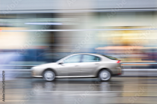 Car in motion blur, car driving fast in the city