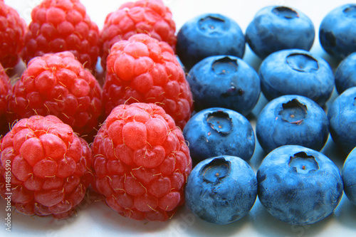 closeup of a bunch of raspberries and blueberries