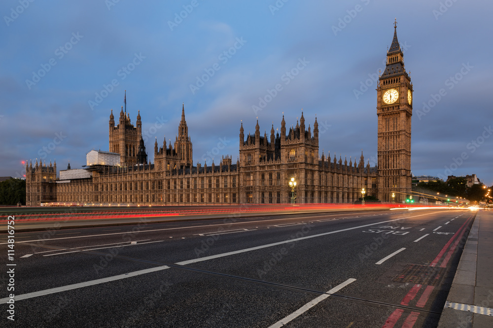 Big Ben, one of the most prominent symbols of both London and England, as shown at night along with the lights of the cars passing 