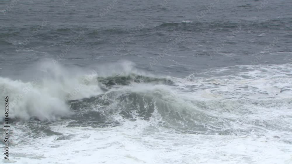 Incoming waves meeting back-surge of surf and bounding upward Incoming waves meeting back-surge of surf and bounding upward