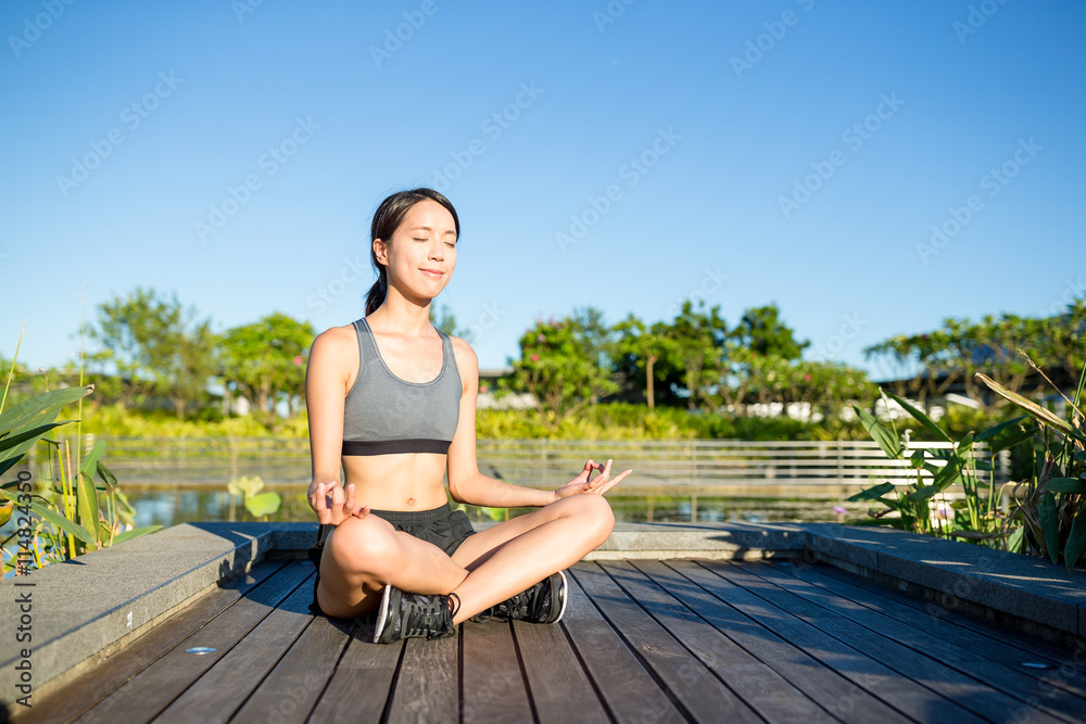 Woman doing Yoga in the park