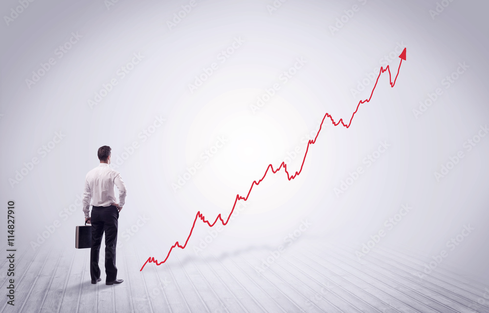 Standing businessman with red graph arrow