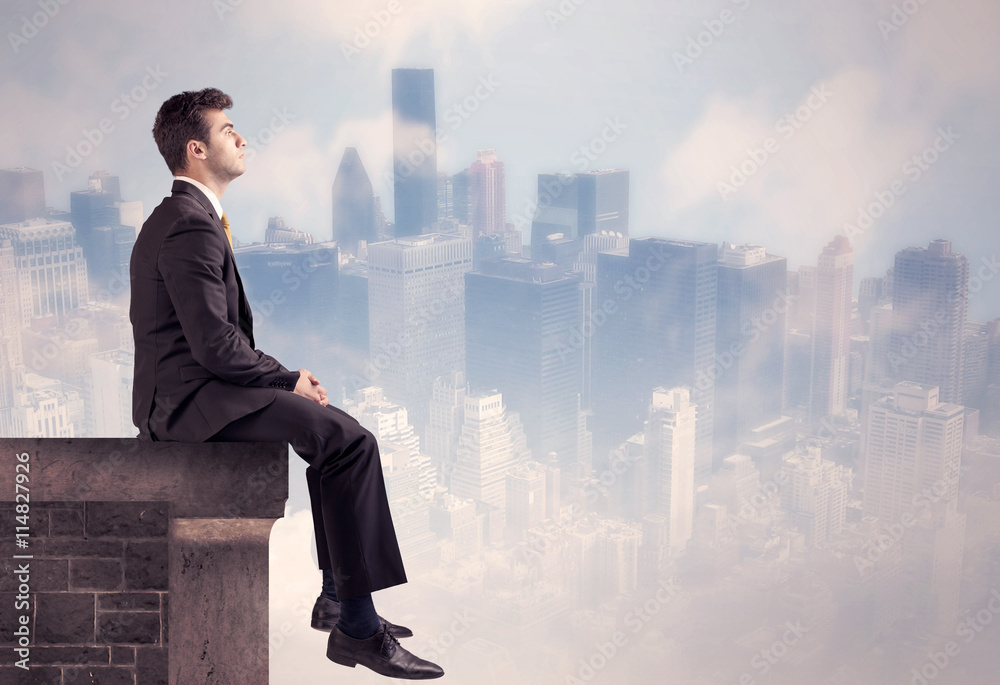 Sales person sitting on top of a tall building Sales person sitting on top of a tall building
