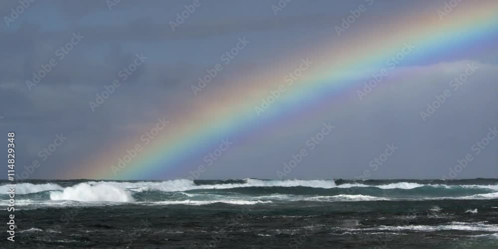 Rainbow over white-capped ocean waves Rainbow over white-capped ocean waves