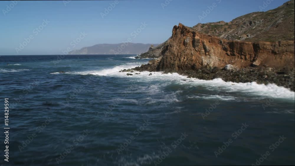 Along the Catalina coastline, dramatic low flight over surf-washed rock formations. Shot in 2010. Along the Catalina coastline, dramatic low flight over surf-washed rock formations. Shot in 2010.