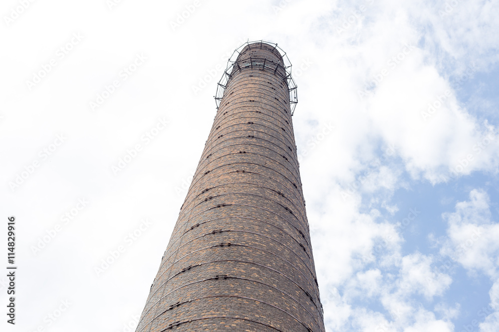 View at tall red brick tower against cloudy sky