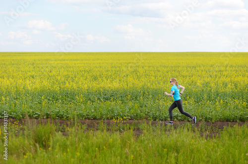 Runner woman running on road in beautiful nature.