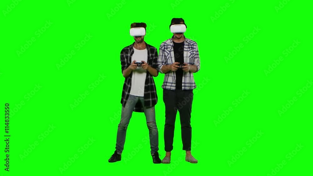 Two mans playing game using VR-helmet. Green screen Two mans playing game using VR-helmet. Green screen