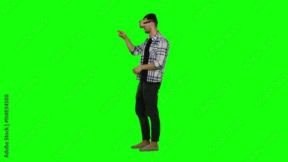 Man wearing virtual reality goggles. Using gestures with hands. Green screen Man wearing virtual reality goggles. Using gestures with hands. Green screen