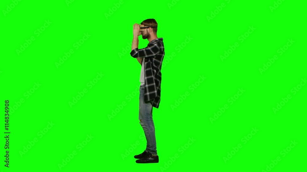 Virtual reality gamer playing with a VR headset. Green screen