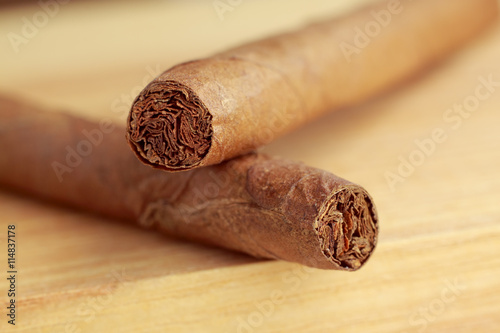 Cigars on wooden board