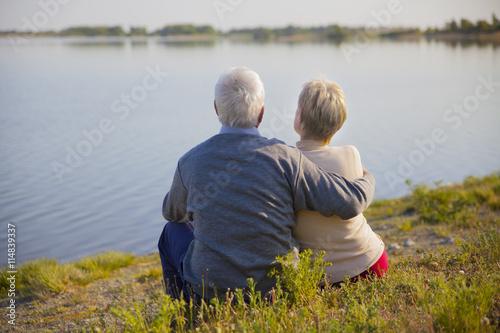 adult couple seniors on the shore of lake
