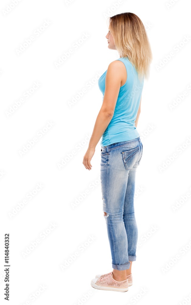 Fototapeta premium back view of standing young beautiful woman.