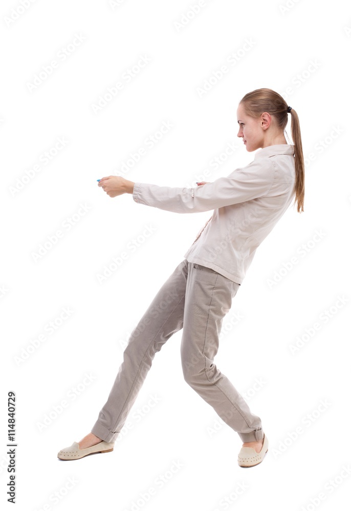 back view of standing girl pulling a rope from the top or cling back view of standing girl pulling a rope from the top or cling
