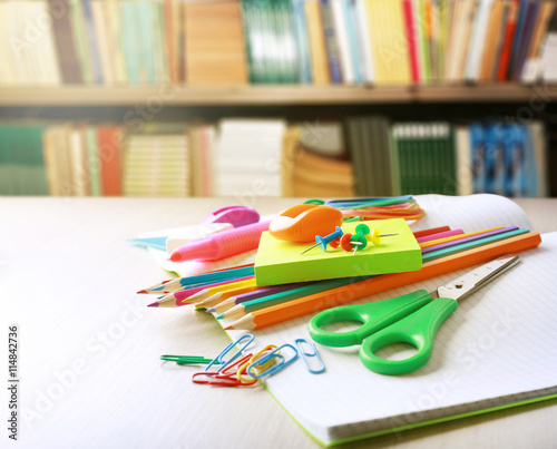 School supplies on blurred library background