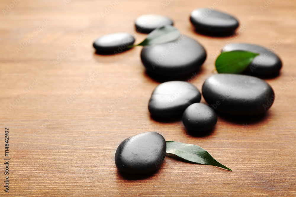 Heap of spa hot stones on wooden background Heap of spa hot stones on wooden background