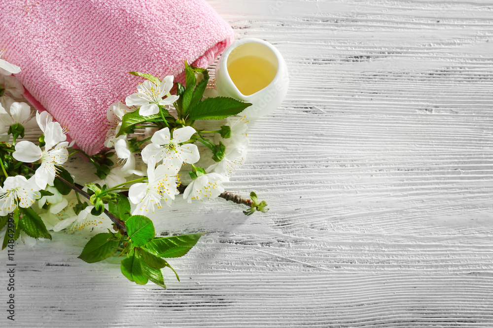 Spa treatment with blooming branch on white wooden table Spa treatment with blooming branch on white wooden table