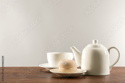 White ceramic tea set on wooden table